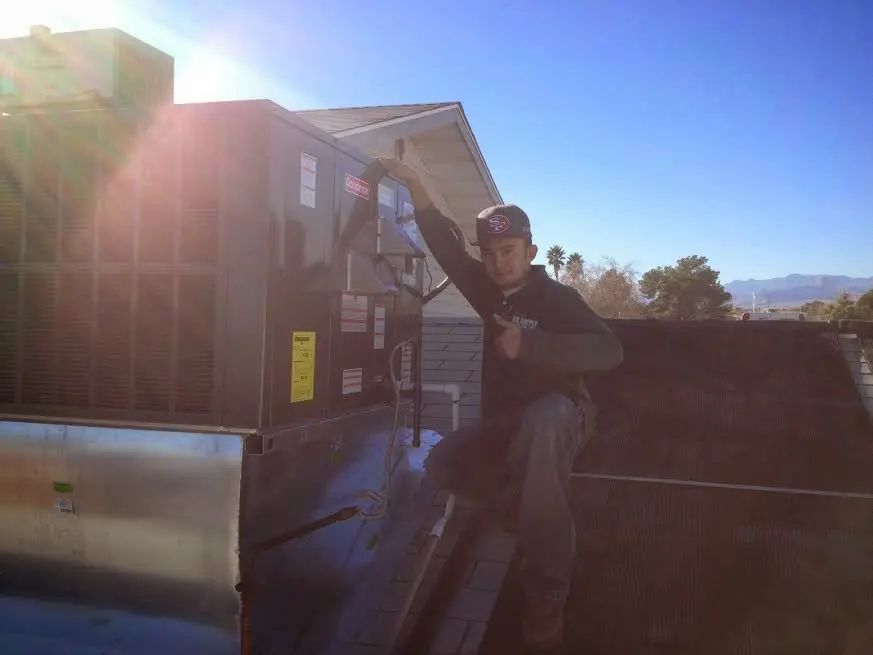 HVAC technician performing HVAC Inspection on a rooftop unit in Lehigh
